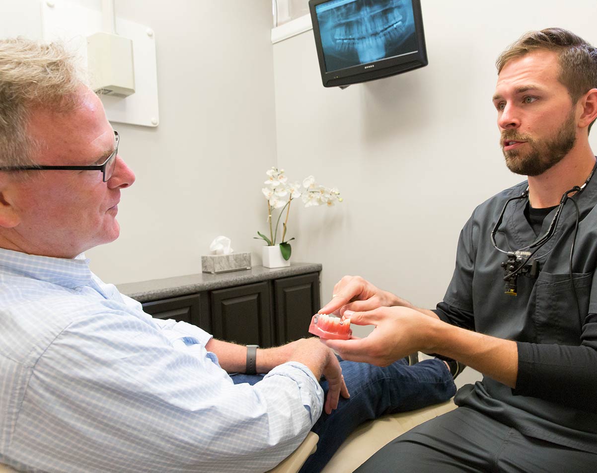 Dr. Wooten and a patient discussing dentures