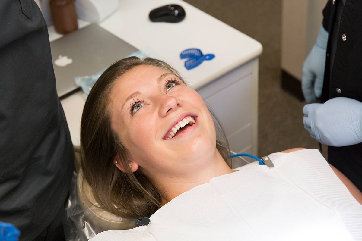 Woman in dental chair smiling