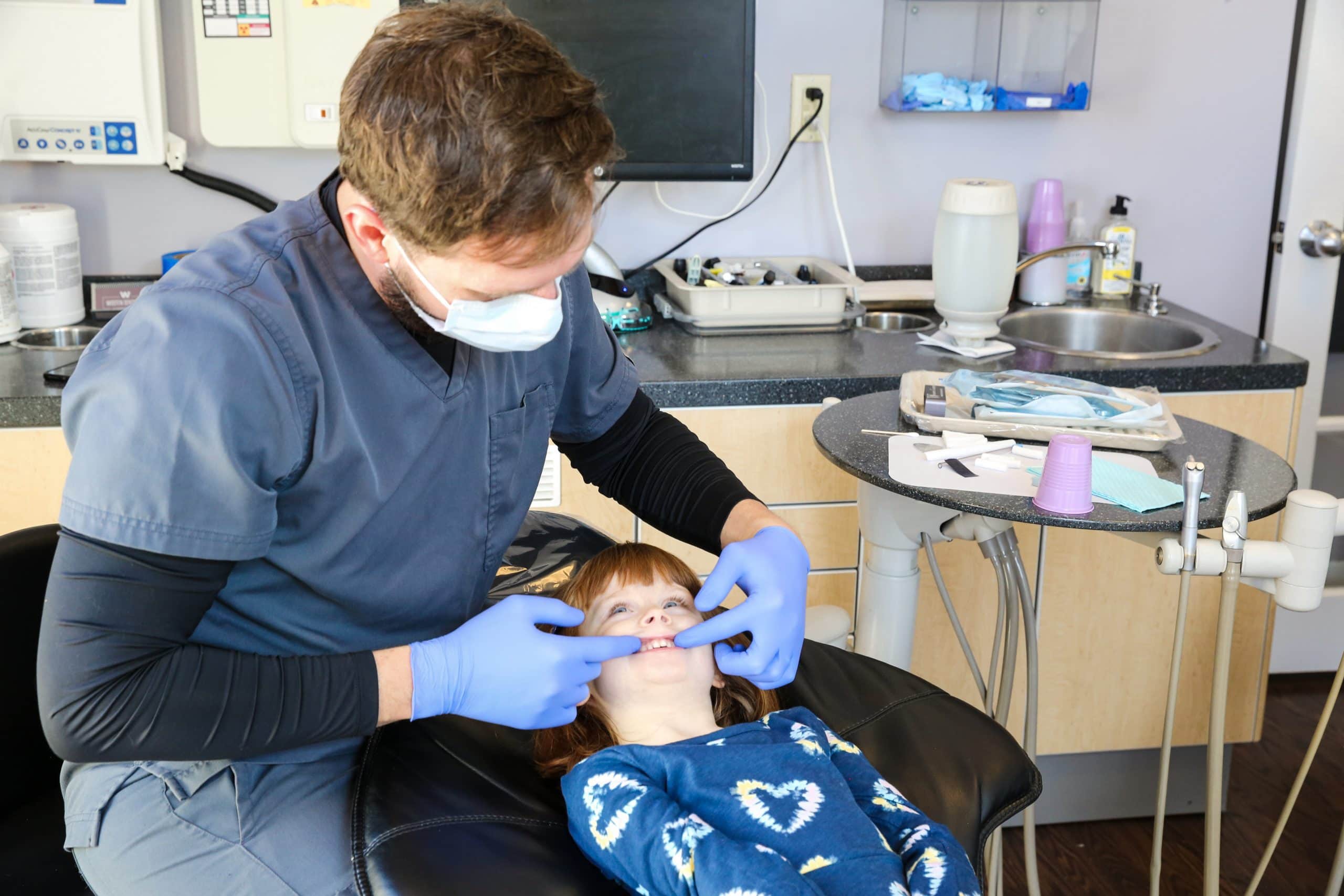 checking child's teeth